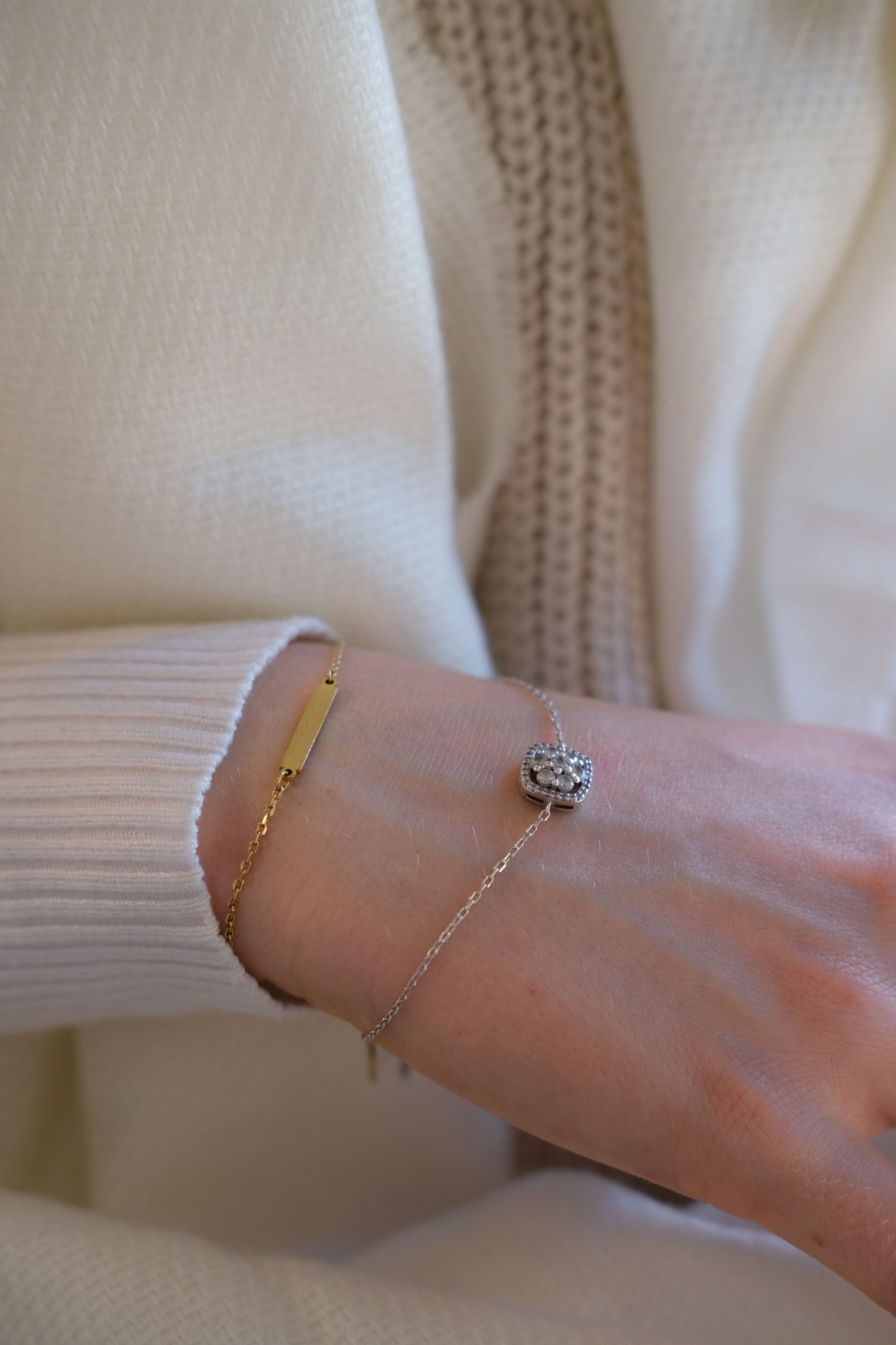 Stylish close-up shot of a wrist showcasing gold and silver bracelets, perfect for fashion and jewelry enthusiasts.